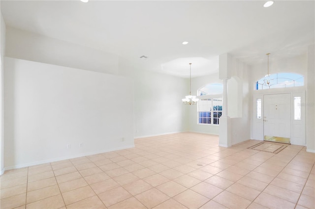 foyer entrance with a notable chandelier, recessed lighting, baseboards, and light tile patterned floors