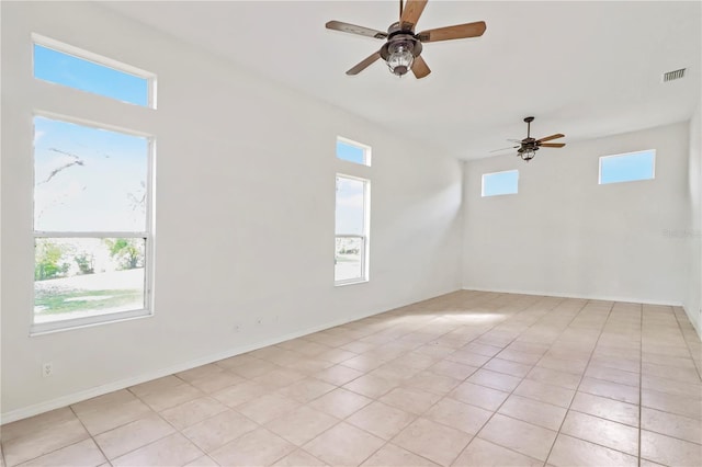 unfurnished room featuring visible vents, baseboards, and a ceiling fan