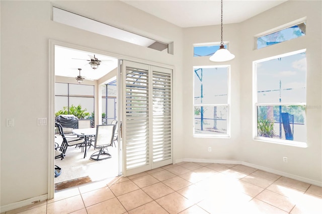 doorway to outside with light tile patterned floors and a healthy amount of sunlight