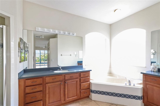 full bathroom featuring a bath, visible vents, tile patterned flooring, and vanity