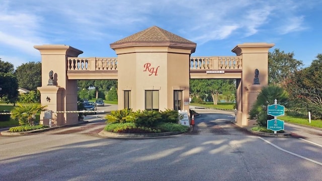 exterior space featuring a gated entry and curbs