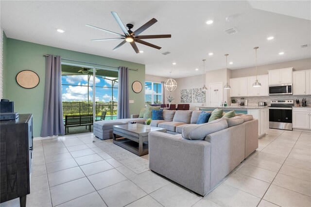 living area featuring light tile patterned floors, visible vents, and recessed lighting