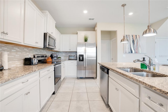 kitchen featuring visible vents, a sink, white cabinetry, appliances with stainless steel finishes, and light tile patterned flooring