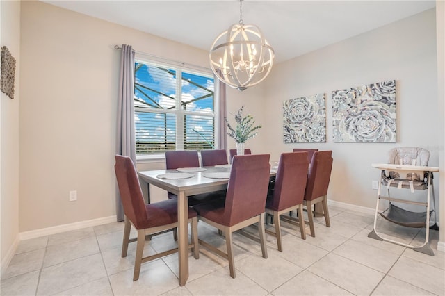 dining area with a chandelier, baseboards, and light tile patterned flooring