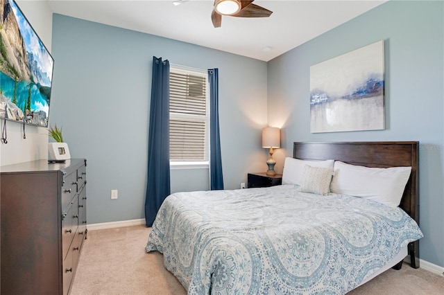 bedroom featuring baseboards, light carpet, and a ceiling fan