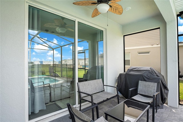 sunroom / solarium featuring ceiling fan