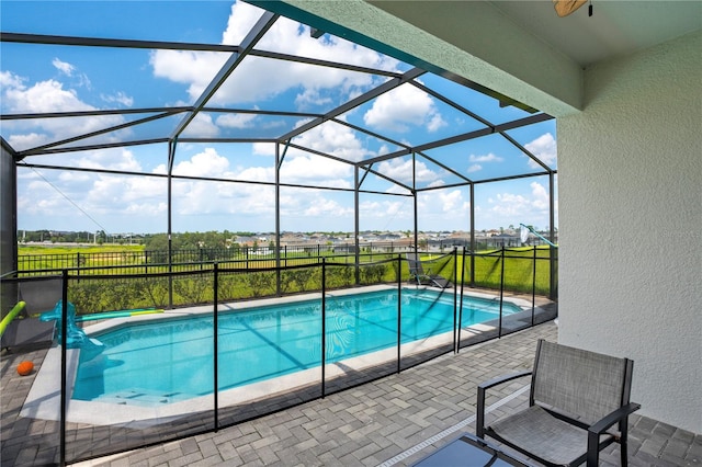 outdoor pool with a patio and a lanai