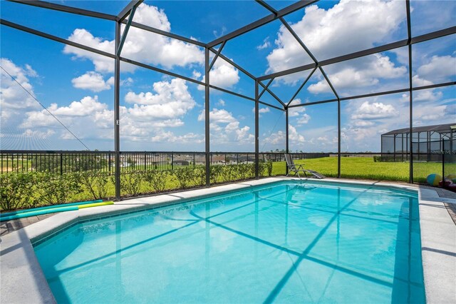 view of swimming pool featuring a fenced in pool, glass enclosure, a yard, and fence