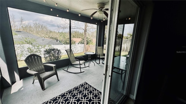 sunroom / solarium featuring ceiling fan