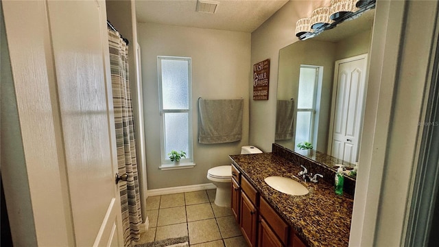 bathroom with visible vents, toilet, tile patterned flooring, baseboards, and vanity