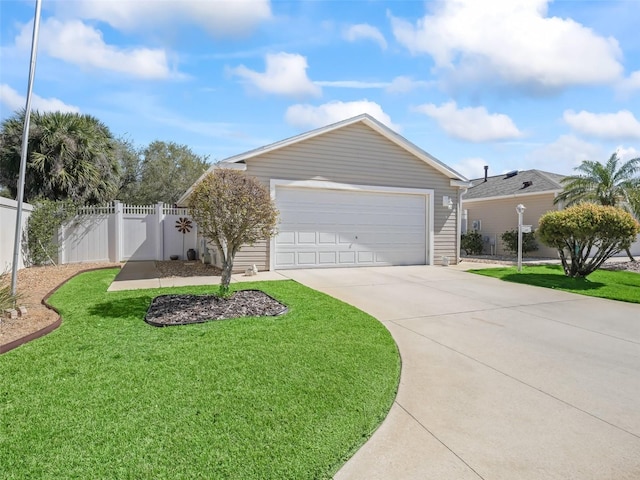 view of front facade with concrete driveway, a front lawn, a garage, and fence