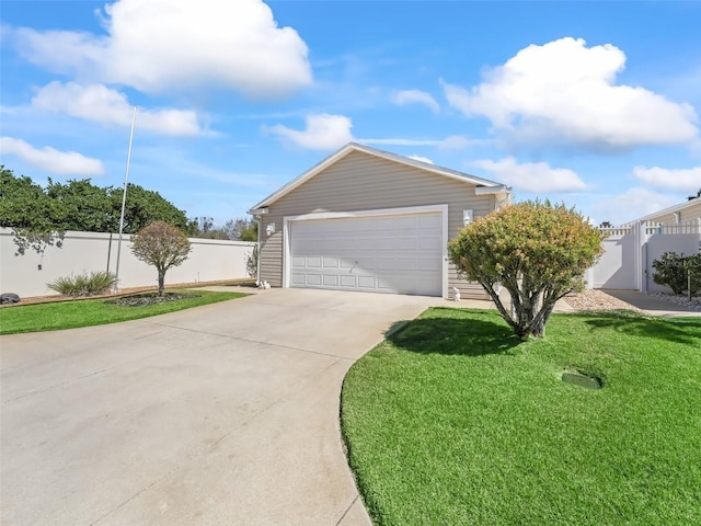 exterior space with a garage, a yard, and fence