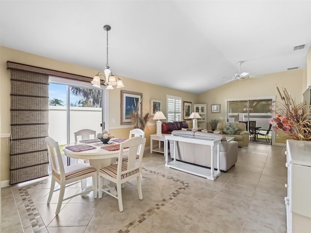 dining room featuring light tile patterned floors, visible vents, baseboards, lofted ceiling, and ceiling fan with notable chandelier