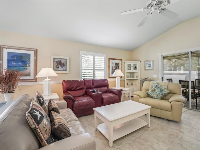 living room with vaulted ceiling, light tile patterned flooring, and a ceiling fan