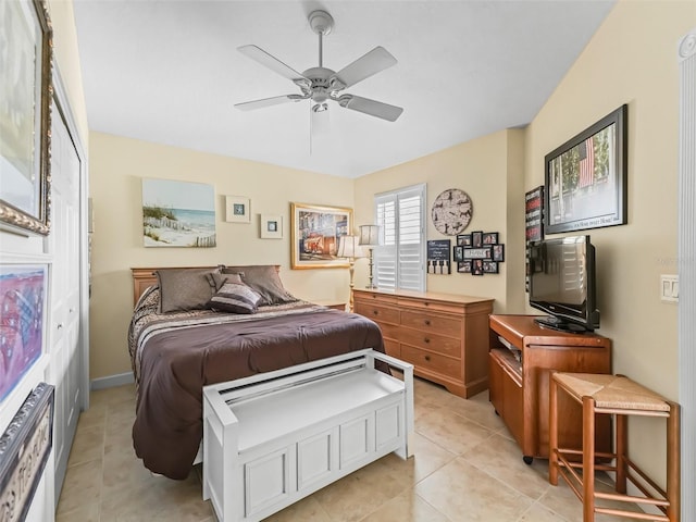 bedroom with light tile patterned floors, baseboards, and a ceiling fan