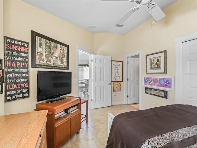 bedroom with lofted ceiling, light tile patterned flooring, and visible vents