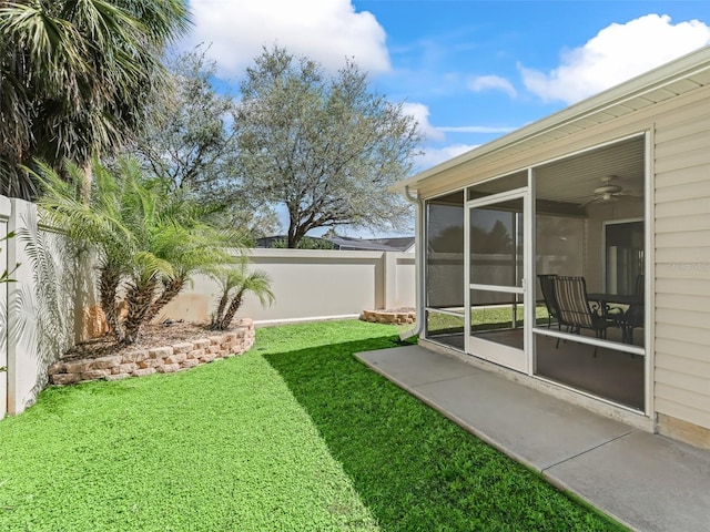 view of yard with a fenced backyard and a sunroom