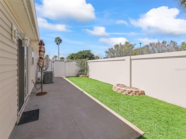 view of patio with central air condition unit, fence, and a gate