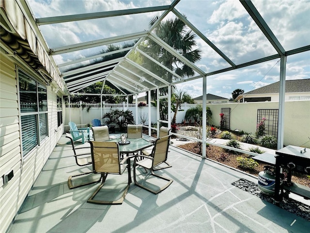 sunroom featuring outdoor dining space