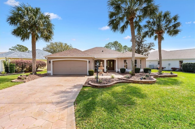 ranch-style house with stucco siding, an attached garage, concrete driveway, and a front lawn