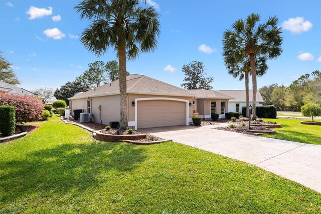 single story home with a front lawn, an attached garage, driveway, and stucco siding