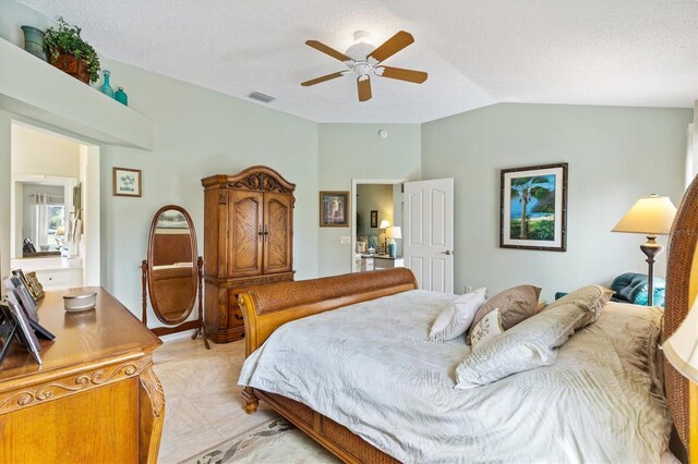 bedroom featuring visible vents, a textured ceiling, lofted ceiling, and a ceiling fan