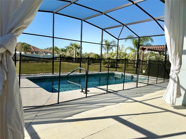 pool with glass enclosure, a yard, and a patio area