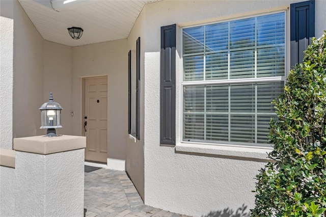 doorway to property with stucco siding