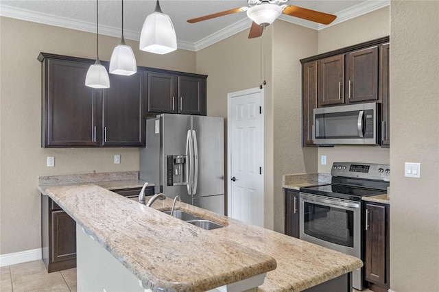 kitchen featuring an island with sink, ornamental molding, a sink, appliances with stainless steel finishes, and dark brown cabinets