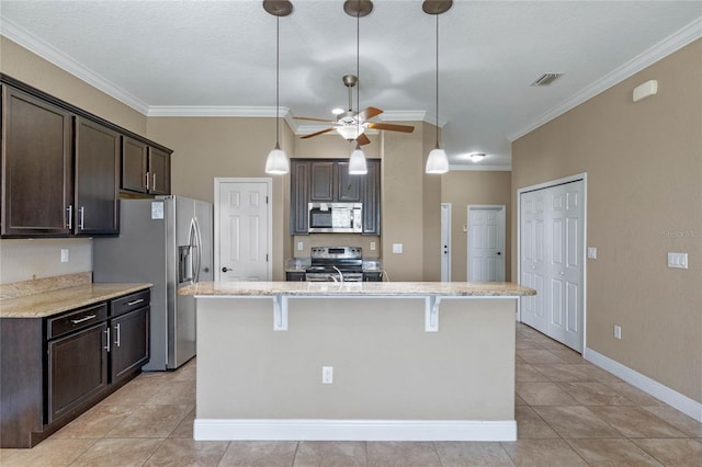 kitchen with visible vents, a kitchen island with sink, stainless steel appliances, crown molding, and dark brown cabinets