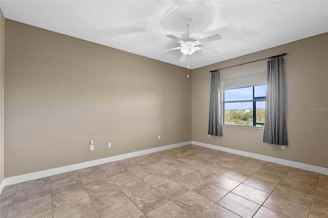 empty room featuring baseboards and ceiling fan