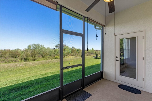 unfurnished sunroom with a ceiling fan