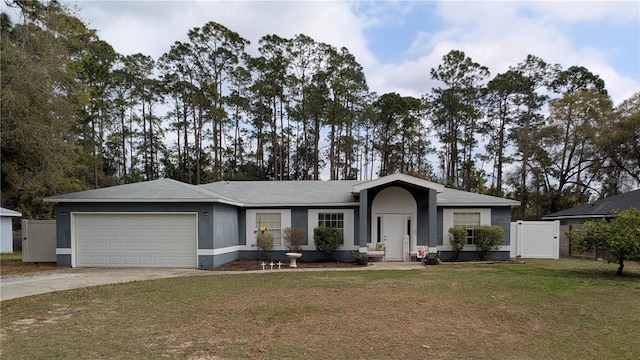 single story home featuring stucco siding, driveway, a front lawn, a gate, and an attached garage