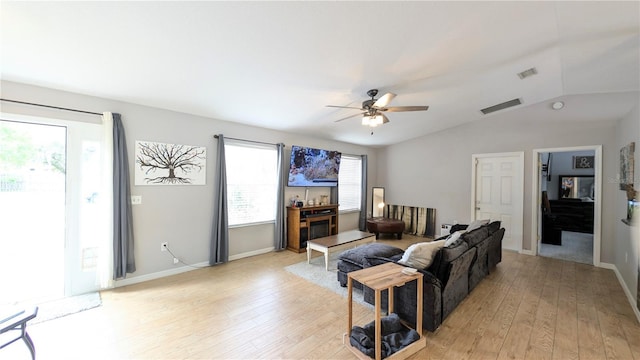 living area with visible vents, lofted ceiling, baseboards, and light wood finished floors