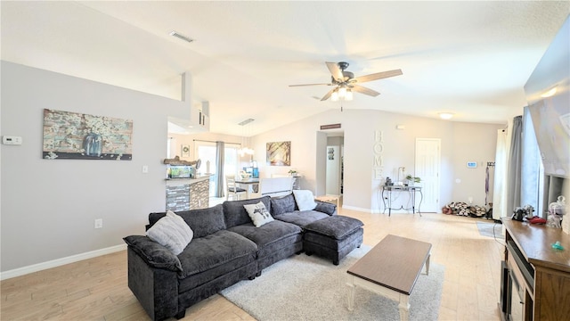 living area featuring visible vents, baseboards, light wood-type flooring, vaulted ceiling, and a ceiling fan