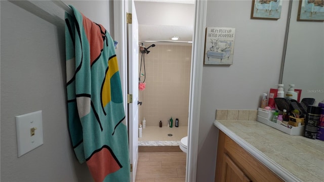 full bath featuring a stall shower, toilet, and wood finished floors