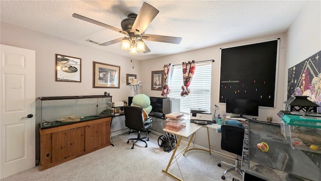 office with a textured ceiling, a ceiling fan, visible vents, and light carpet