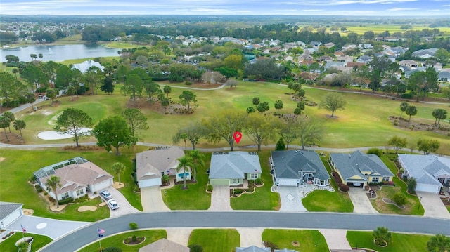 aerial view featuring a residential view, golf course view, and a water view