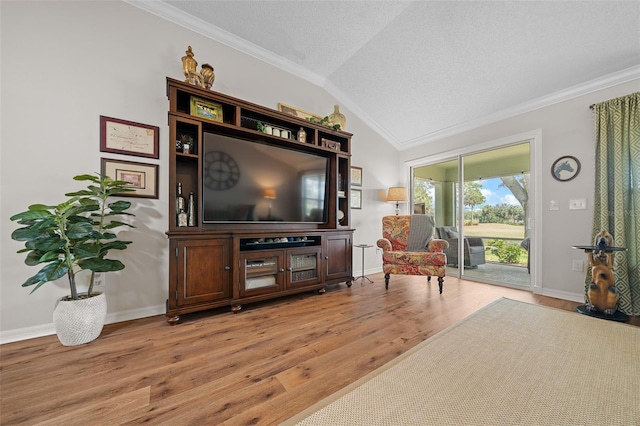 living area featuring lofted ceiling, light wood-style flooring, a textured ceiling, crown molding, and baseboards