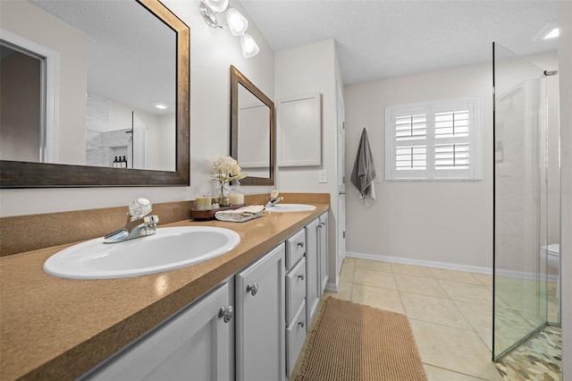 full bathroom featuring a sink, a textured ceiling, walk in shower, and tile patterned flooring