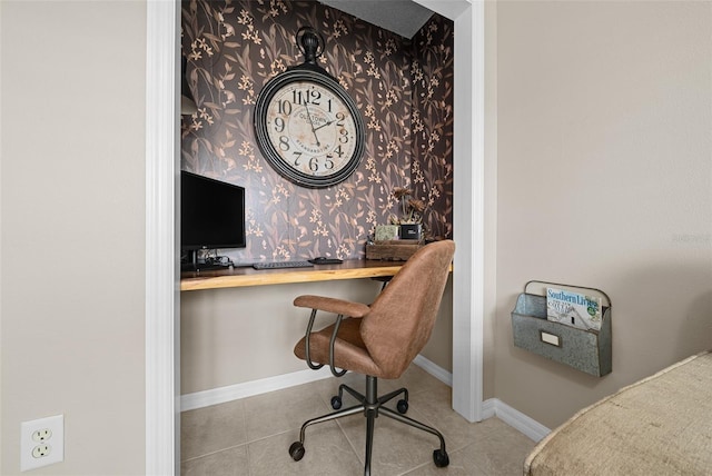 home office with tile patterned floors, wallpapered walls, baseboards, and built in study area