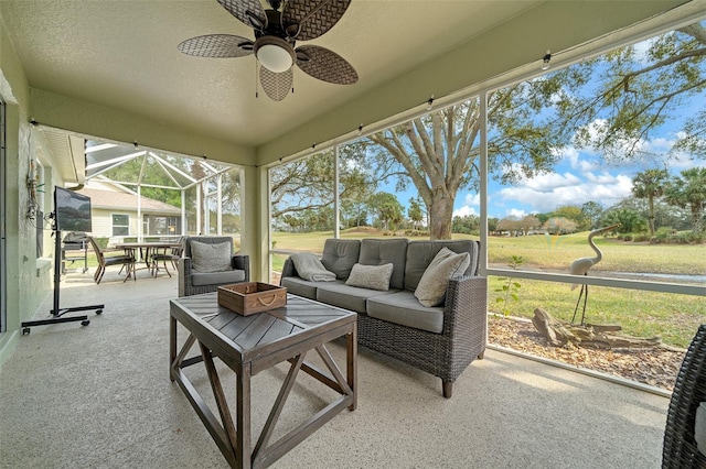 sunroom featuring ceiling fan