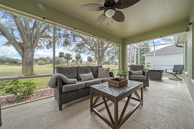 sunroom featuring a ceiling fan