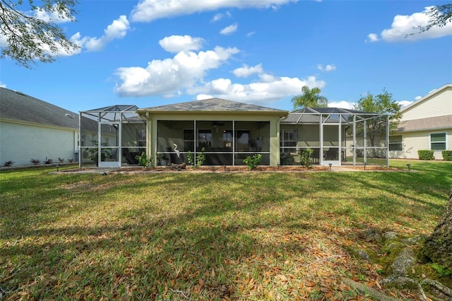 rear view of property featuring a lawn and glass enclosure