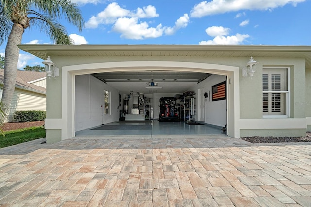 garage with decorative driveway and a garage door opener