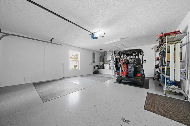 garage featuring electric panel, electric water heater, a garage door opener, and concrete block wall