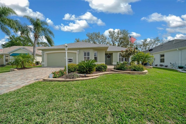 ranch-style home featuring a front lawn, decorative driveway, a garage, and stucco siding