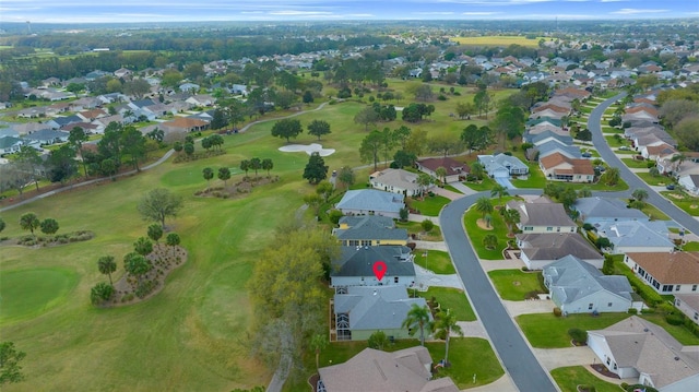 drone / aerial view with view of golf course and a residential view