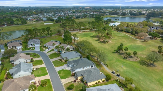 drone / aerial view featuring a residential view, a water view, and view of golf course