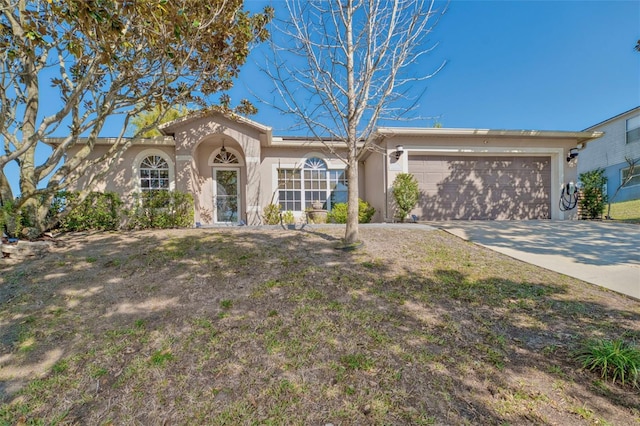 view of front of property with a garage, driveway, and stucco siding